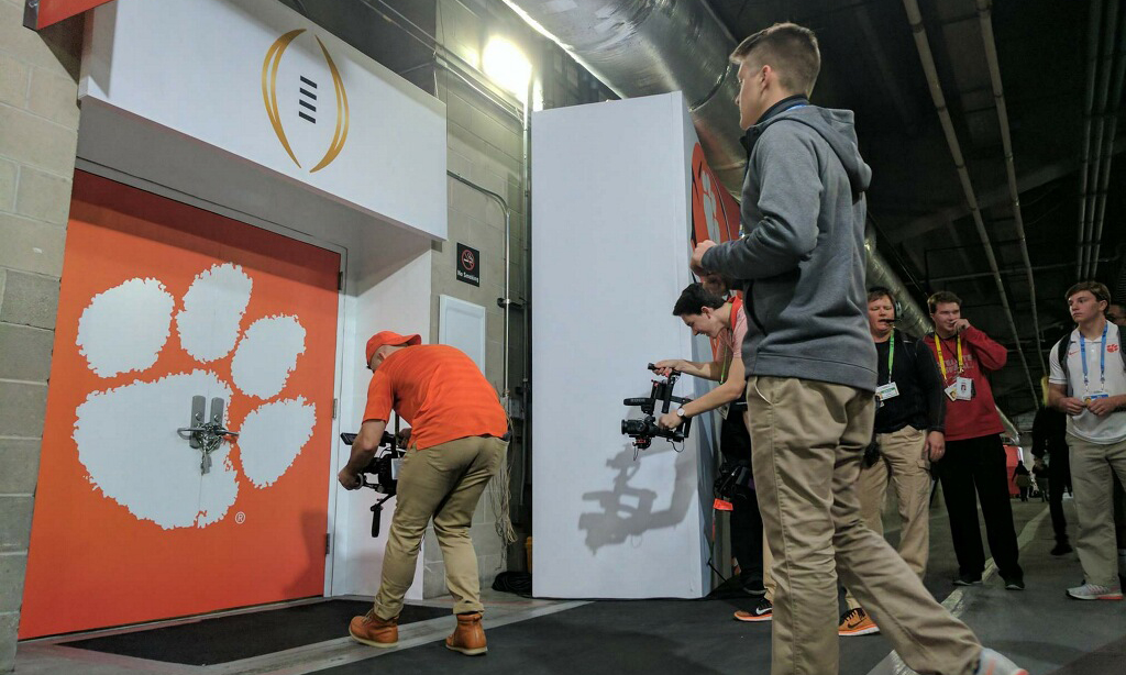 Nik Conklin (shooting in orange shirt) takes pride in being able to react to stories on the fly, as he did here when the Tigers' locker room was chained shut on the day of the National Championship Game.