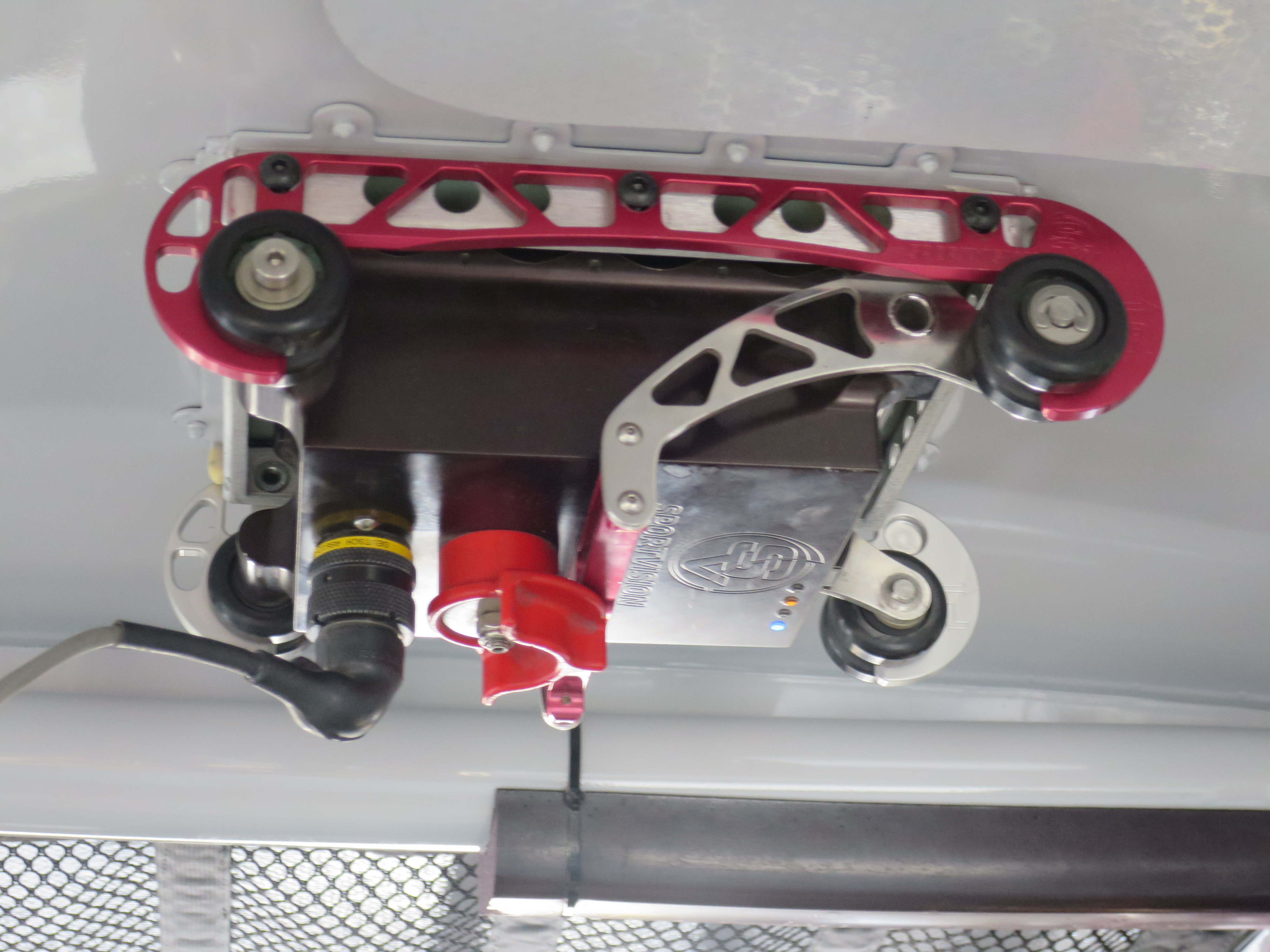A small onboard computer is mounted to the inside of the roof of the race cars.